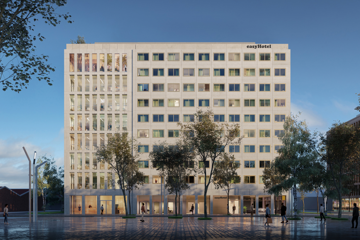 Exterior view of the modern easyHotel Paris Nord Aubervilliers, a multi-story building with a light grey facade and numerous windows, featuring offices on the left and easyHotel rooms on the right. Trees and pedestrians are on the street level in front of