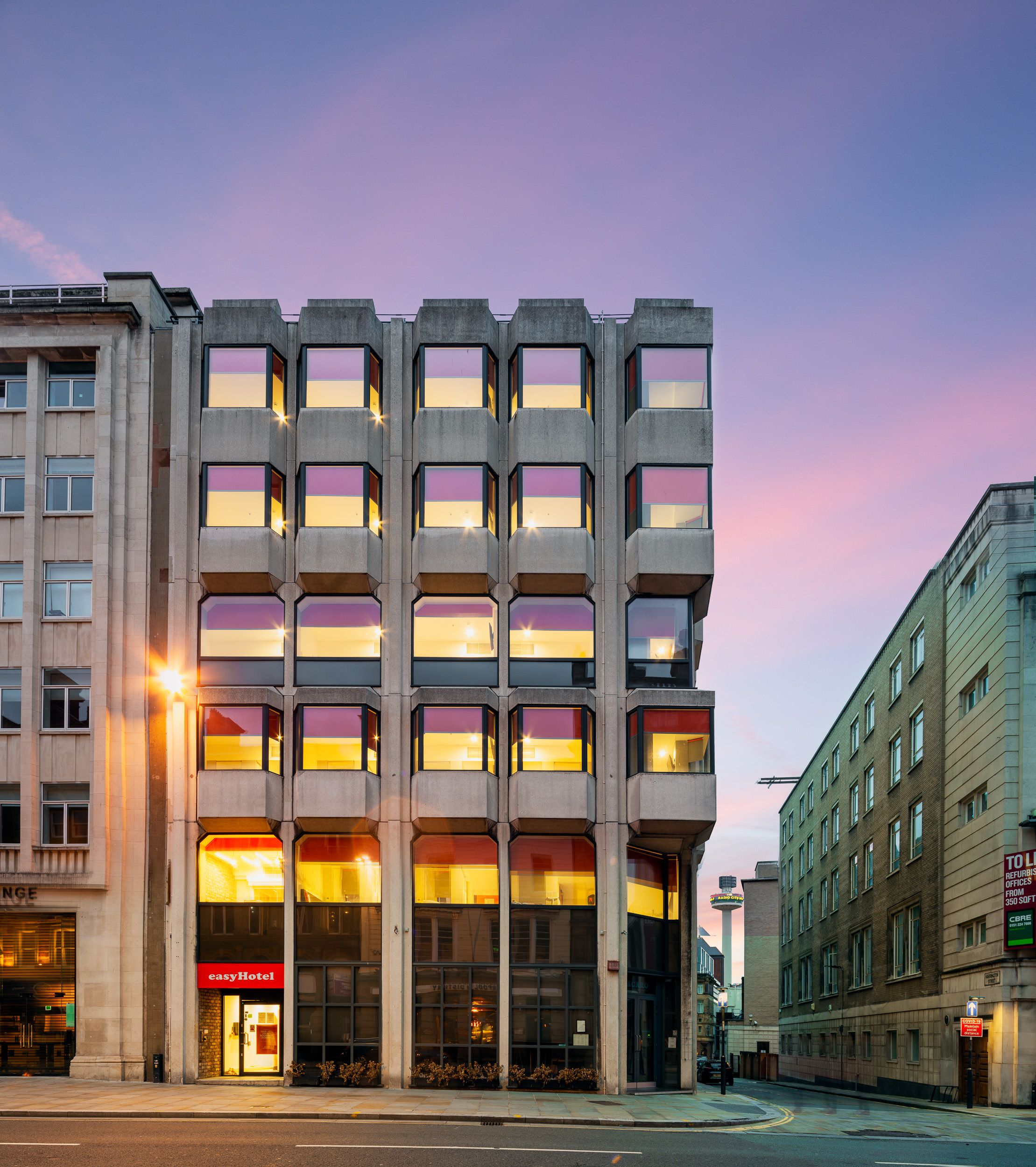 EasyHotel Liverpool city centre building exterior at dusk, with the Radio City Tower in the background.