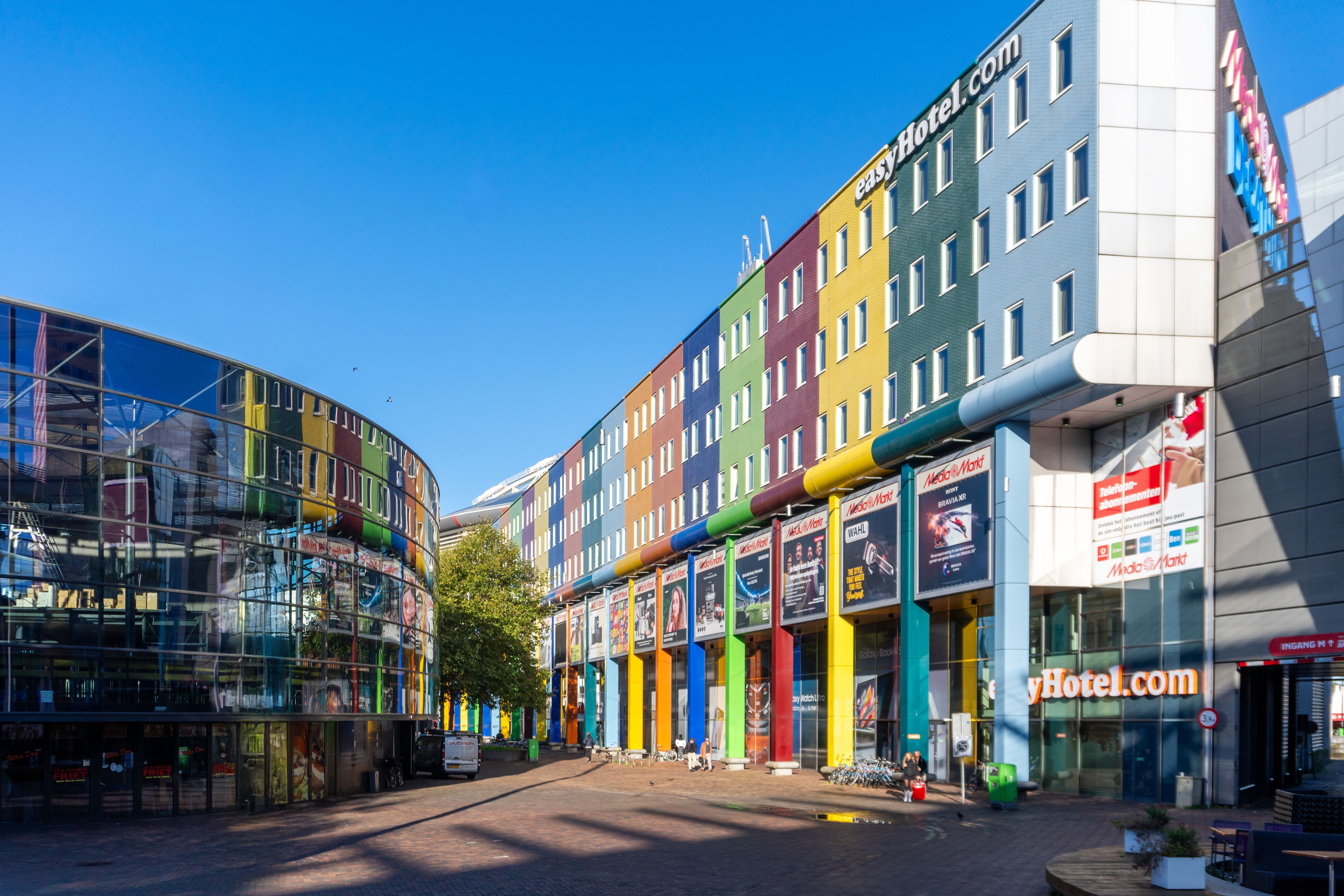 easyHotel Amsterdam Arena exterior building with a vibrant, multi-colored facade under a bright blue sky.